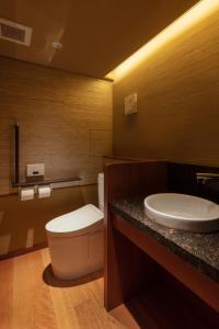 a bathroom with a toilet and a sink at Sora Niwa Terrace Kyoto Bettei in Kyoto