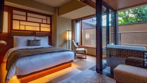 a bedroom with a large bed and a window at Sora Niwa Terrace Kyoto Bettei in Kyoto