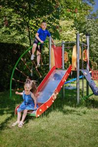 a boy and a girl playing on a playground at Hotel Młyn Aqua Spa in Elblag