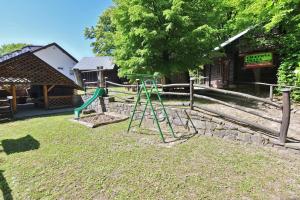 a playground with a ladder and a swing at Chatová Osada Zrub in Vinné