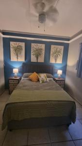 a bedroom with a bed with three pictures on the wall at Aloe Cottage - Ramsgate Ramble Rest in Margate +10 photos