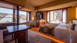 a bedroom with a bed and a living room with a view at Sora Niwa Terrace Kyoto Bettei in Kyoto