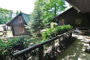 a wooden cabin with a fence in front of it at Chatová Osada Zrub in Vinné +9 photos
