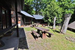 a picnic table in the grass next to a building at Chatová Osada Zrub in Vinné