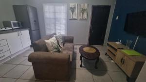 a living room with a couch and a table at Aloe Cottage - Ramsgate Ramble Rest in Margate