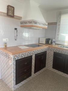 a kitchen with a wooden counter top in a room at Villa Familia in Écija
