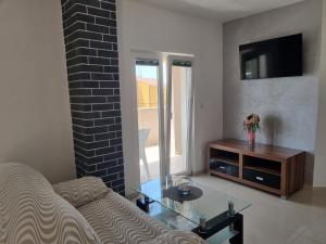 Televízia a/alebo spoločenská miestnosť v ubytovaní Jurić Apartments