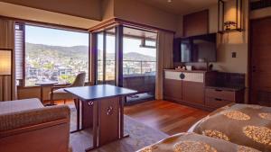 a living room with a view of a city at Sora Niwa Terrace Kyoto Bettei in Kyoto