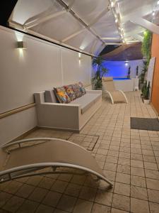 a room with a couch and chairs on a tile floor at CASAeMARE in Porto SantʼElpidio