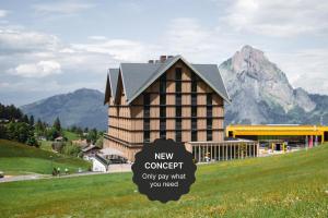 a building with a new concept sign in front of it at Stoos Lodge in Stoos
