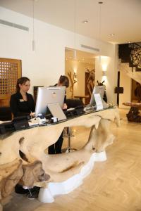 two women sitting at a desk with laptops at Hôtel Campo Dell'oro in Ajaccio