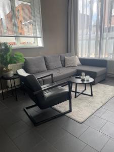 a living room with a couch and a chair at Stadsappartement Valkhof in Nijmegen +20 photos