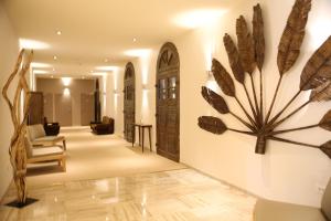 a living room with a large feather sculpture on the wall at Hôtel Campo Dell'oro in Ajaccio
