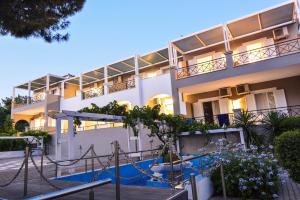 an apartment building with a slide in front of it at Epavlis Beach Resort in Porto Heli