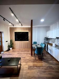 a living room with a table and chairs and a kitchen at Pogradeci Lake Guest House in Pogradec