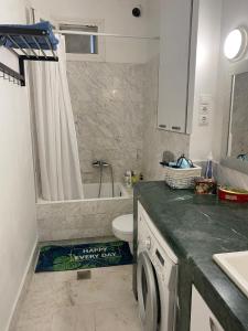a bathroom with a toilet and a sink and a washing machine at Lovely place in Perea in Perea +6 photos