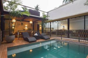 a house with a swimming pool next to a building at VILLA MARTINA with private swimming pool in El Nido