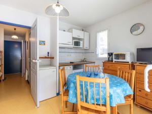 a kitchen with a table and chairs in a kitchen at Appartement cosy Cauterets, balcon sud, proche centre & télécabine, 4 pers, parking inclus - FR-1-401-15 in Cauterets