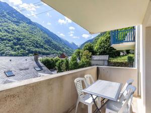 a table and chairs on a balcony with a view at Appartement cosy Cauterets, balcon sud, proche centre & télécabine, 4 pers, parking inclus - FR-1-401-15 in Cauterets +10 photos