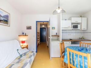 a kitchen and a bedroom with a bed and a table at Appartement cosy Cauterets, balcon sud, proche centre & télécabine, 4 pers, parking inclus - FR-1-401-15 in Cauterets