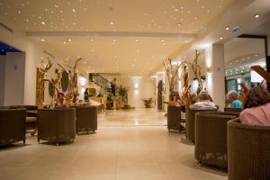 a lobby of a store with people sitting in chairs at Hôtel Campo Dell'oro in Ajaccio
