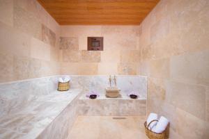 a bathroom with a tub and a sink at Black Stove Cappadocia in Ortahisar