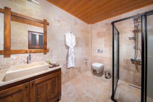 a bathroom with a sink and a shower at Black Stove Cappadocia in Ortahisar
