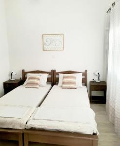 A bed or beds in a room at Theros House