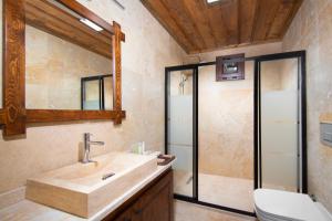 a bathroom with a sink and a shower at Black Stove Cappadocia in Ortahisar