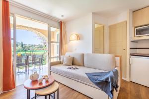 a living room with a couch and a table at Village Pierre & Vacances Cap Esterel in Agay - Saint Raphael