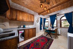 a kitchen with a table and a washing machine at Black Stove Cappadocia in Ortahisar