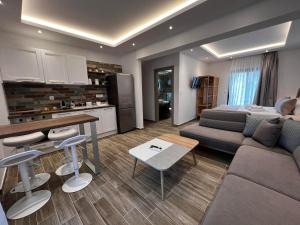 a living room with a couch and a table and a kitchen at House Karga in Ormos Panagias
