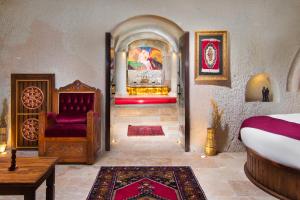 a room with a bed and a couch and a table at Black Stove Cappadocia in Ortahisar