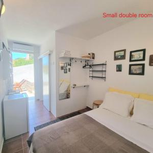 a bedroom with a large bed and a small double room at Panoramic View apartment in Poros