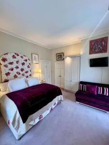 a bedroom with a large bed and a couch at Burlington Townhouse in Dublin