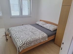 a bed with two pillows on it in a room at Luka in Privlaka