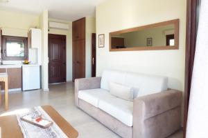 a living room with a couch and a mirror at Gem of Diaporos in Vourvourou +22 photos