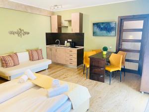 a living room with a bed and a kitchen at Style Residence in Sibiu
