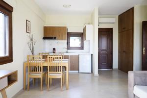 a kitchen and dining room with a table and chairs at Gem of Diaporos in Vourvourou