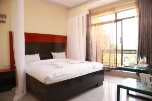 Postel nebo postele na pokoji v ubytování Sunstar Resort Thika