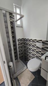 a bathroom with a toilet and a glass shower at La casa di Giuliana piano terra con cucina e lavatrice in Ischia +29 photos