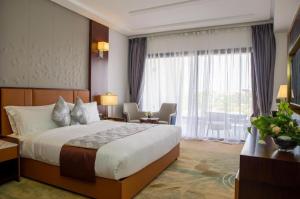 a hotel room with a bed and a large window at Waves Aqua Resort in Kenitra