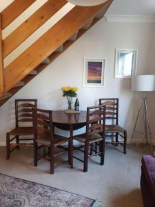 a dining room with a table and two chairs at Lavender Cottage, a pretty period cottage in Louth in Louth