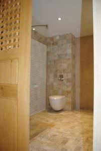 a bathroom with a tub and a toilet in a room at Hôtel Campo Dell'oro in Ajaccio