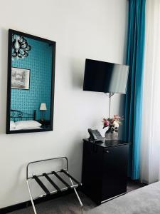 a bedroom with a mirror and a chair and a lamp at Penzion Vila Prešeren in Bled