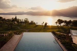a swimming pool with a view of a lake at Cape of Senses in Torri del Benaco +23 photos