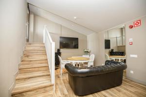 a living room with a couch and a table at Les Clarisses Boutique Hotel in Vic