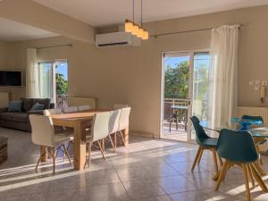 a dining room and living room with a table and chairs at Εolia Central Apartments in Skala Kallirachis