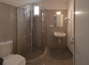 a bathroom with a shower and a toilet and a sink at Simada Green Guesthouse in Varshets +41 photos