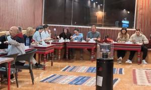 a group of people sitting at tables in a room at Wadi Rum Luxure desert Camp in Wadi Rum